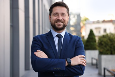 Photo of Portrait of successful businessman near office building