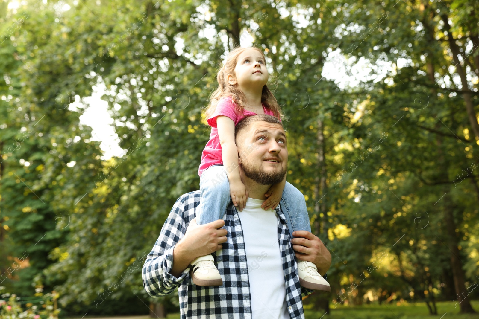 Happy Father's Day. Dad and his little daughter spending time together in park Photo of Happy Father's Day. Dad and his little daughter spending time together in park