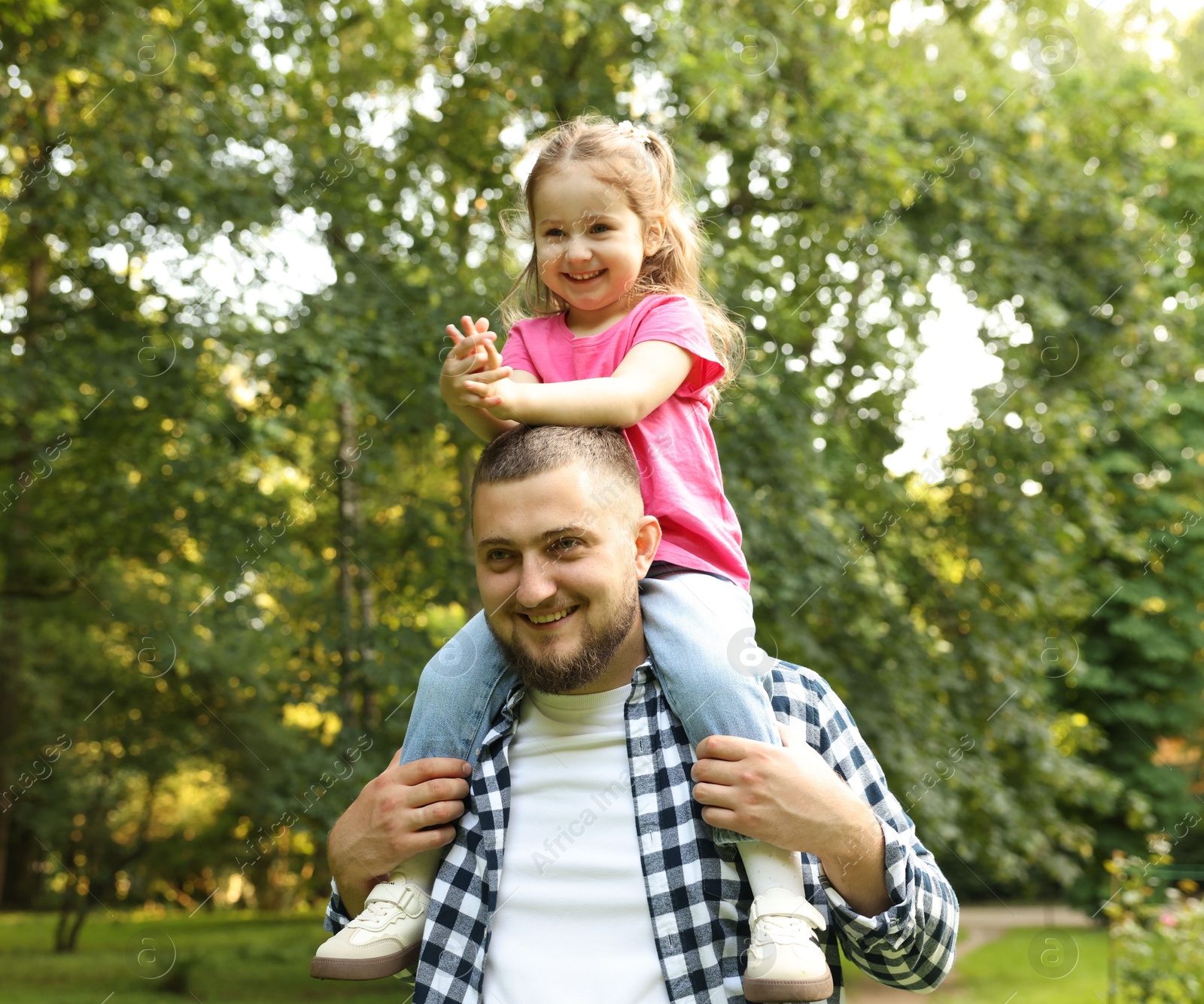 Happy Father's Day. Dad and his little daughter spending time together in park Photo of Happy Father's Day. Dad and his little daughter spending time together in park