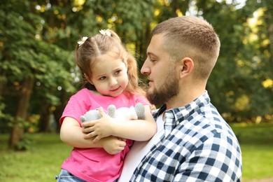 Photo of Happy Father's Day. Dad and his little daughter spending time together in park