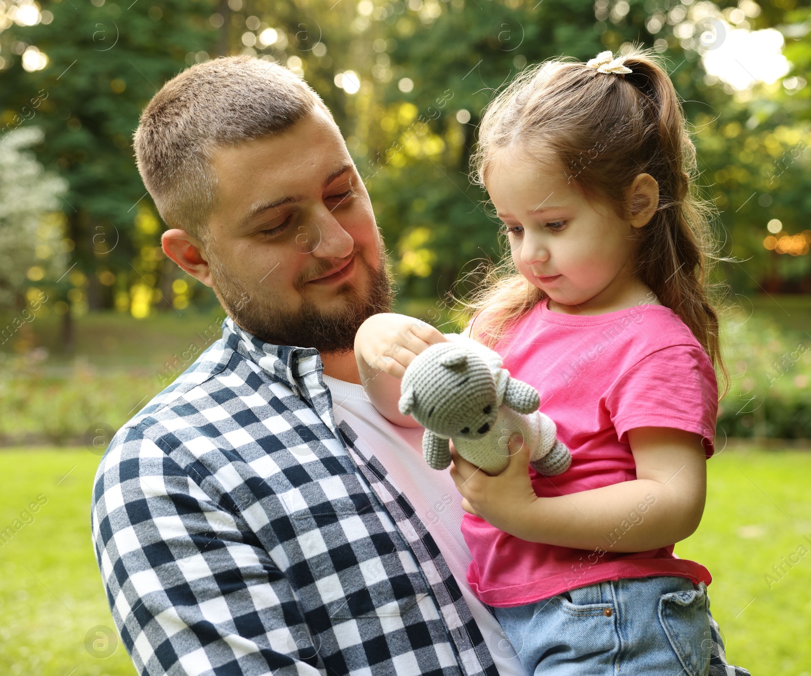 Happy Father's Day. Dad and his little daughter spending time together in park Photo of Happy Father's Day. Dad and his little daughter spending time together in park