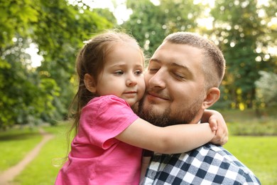 Photo of Happy Father's Day. Dad and his little daughter spending time together in park
