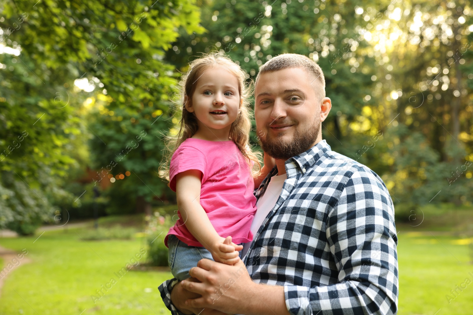 Happy Father's Day. Dad and his little daughter spending time together in park, space for text Photo of Happy Father's Day. Dad and his little daughter spending time together in park, space for text