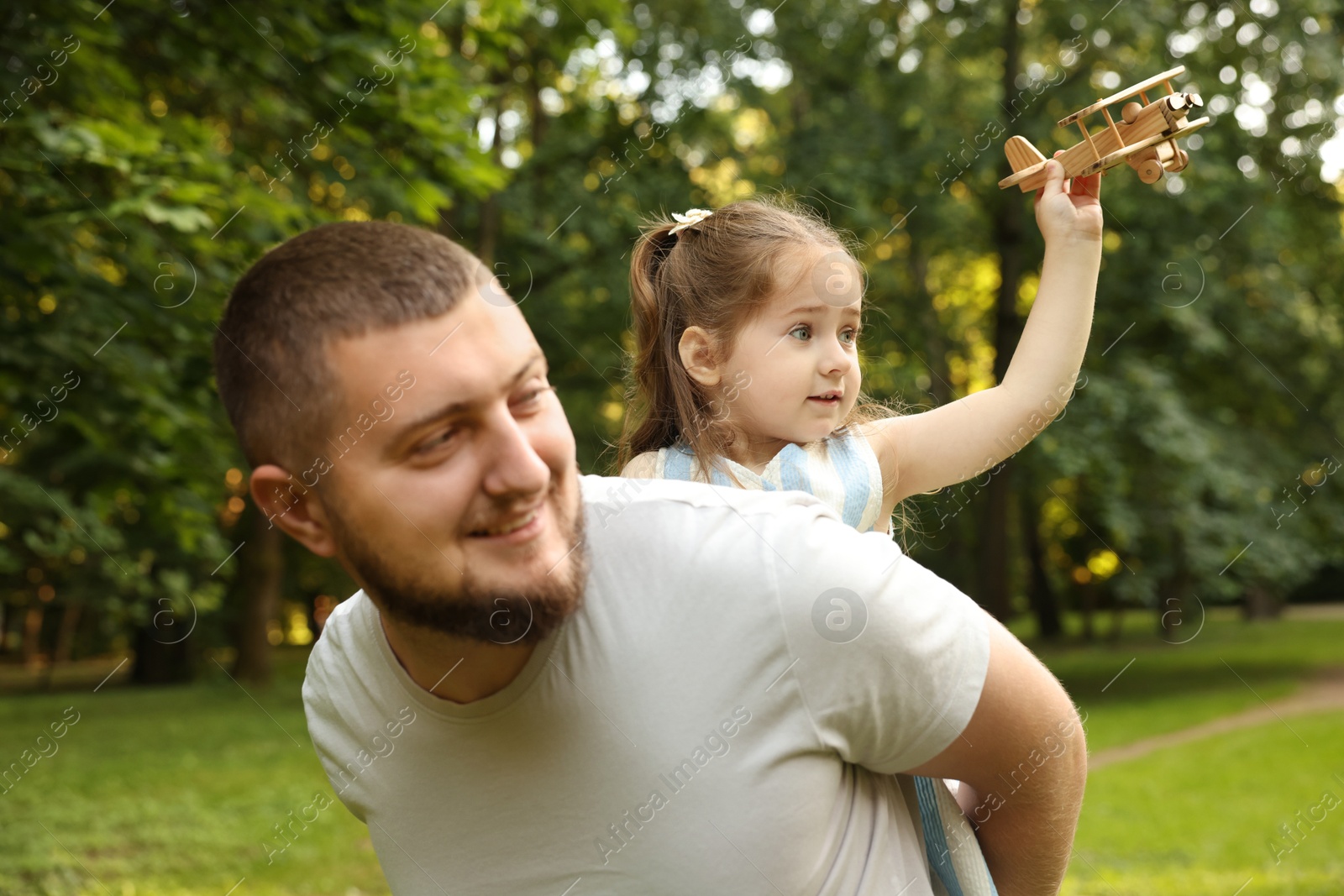 Happy Father's Day. Dad and his little daughter spending time together in park Photo of Happy Father's Day. Dad and his little daughter spending time together in park