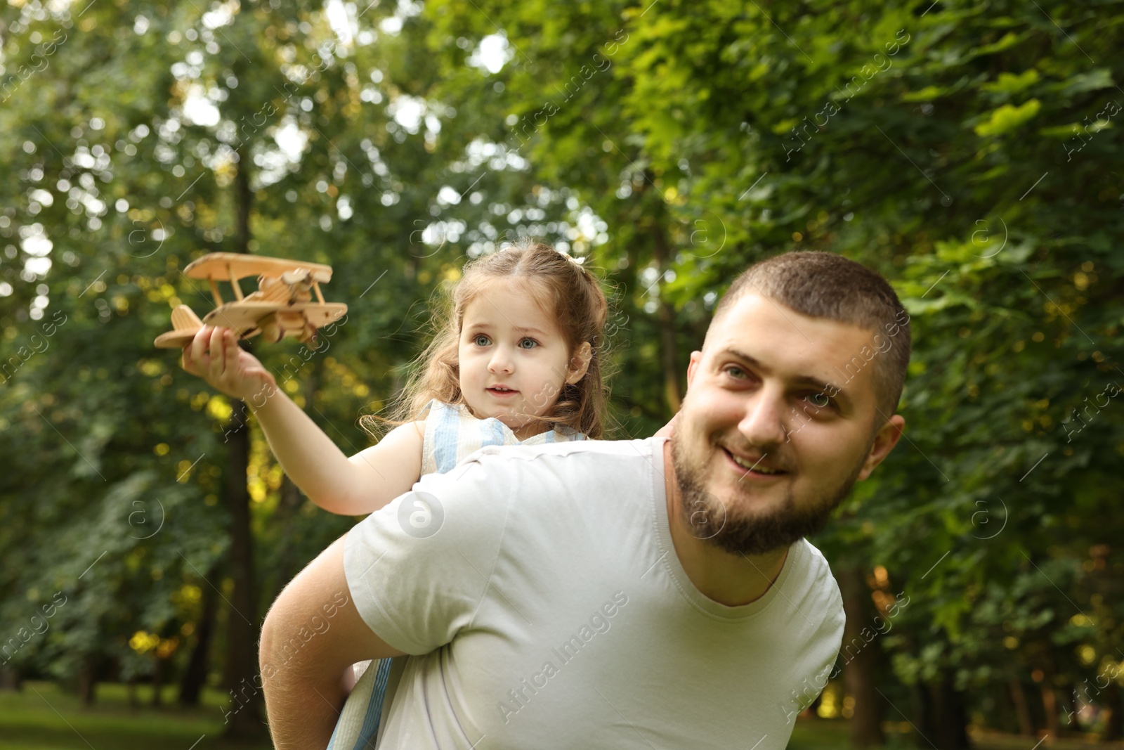 Happy Father's Day. Dad and his little daughter spending time together in park Photo of Happy Father's Day. Dad and his little daughter spending time together in park