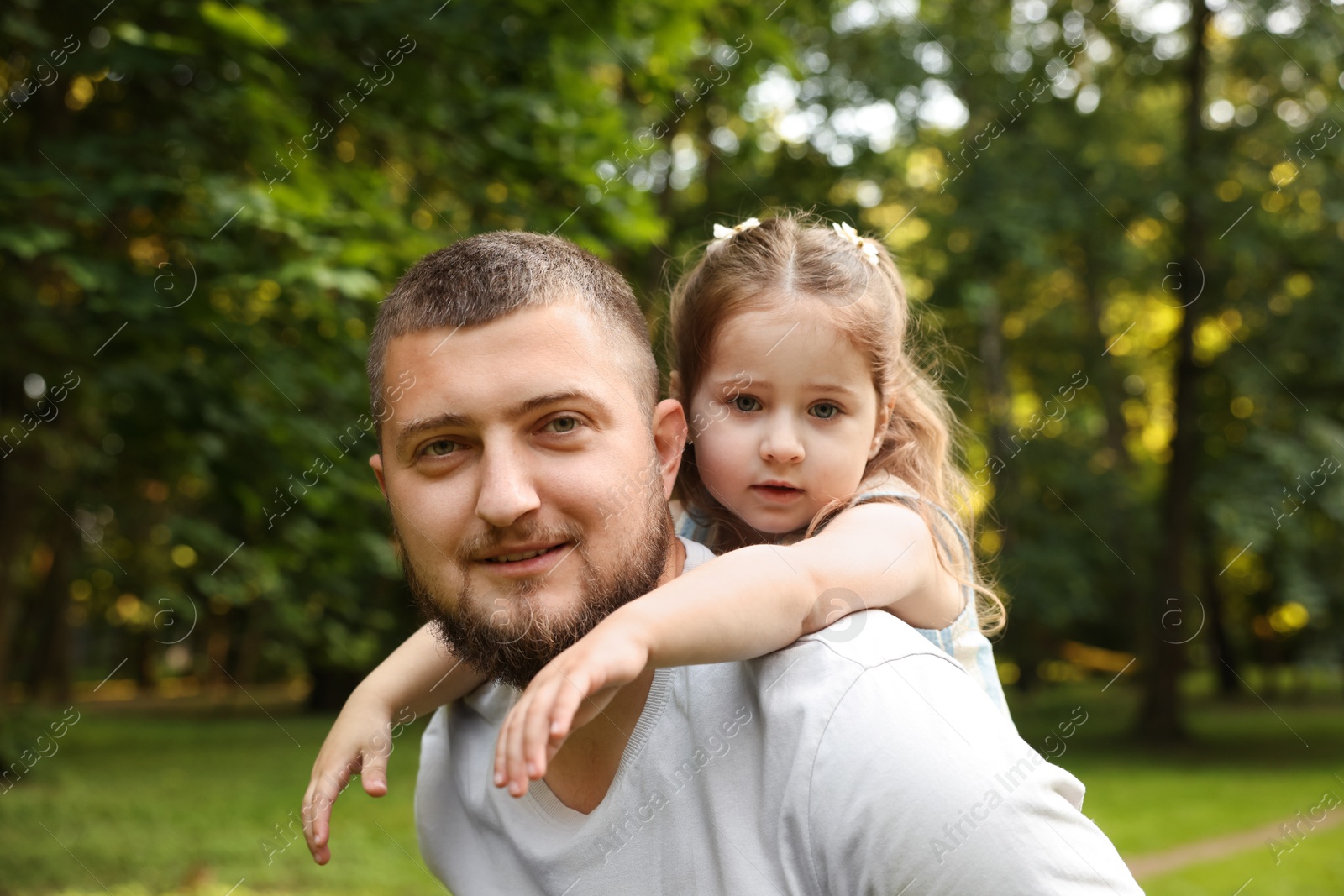 Happy Father's Day. Dad and his little daughter spending time together in park Photo of Happy Father's Day. Dad and his little daughter spending time together in park