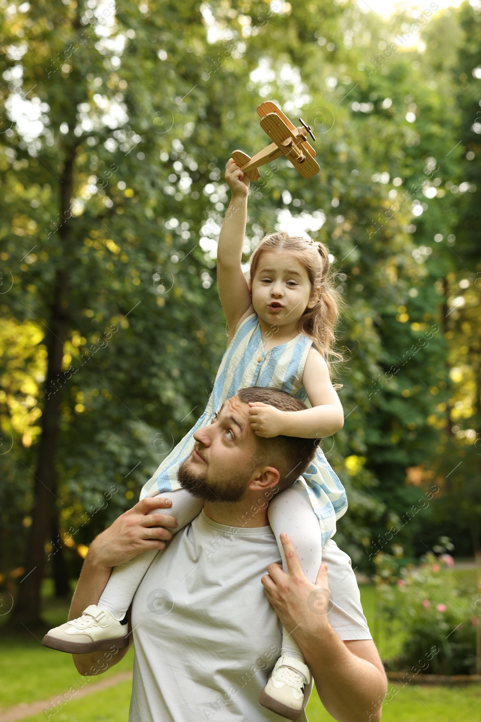 Happy Father's Day. Dad and his little daughter spending time together in park Photo of Happy Father's Day. Dad and his little daughter spending time together in park