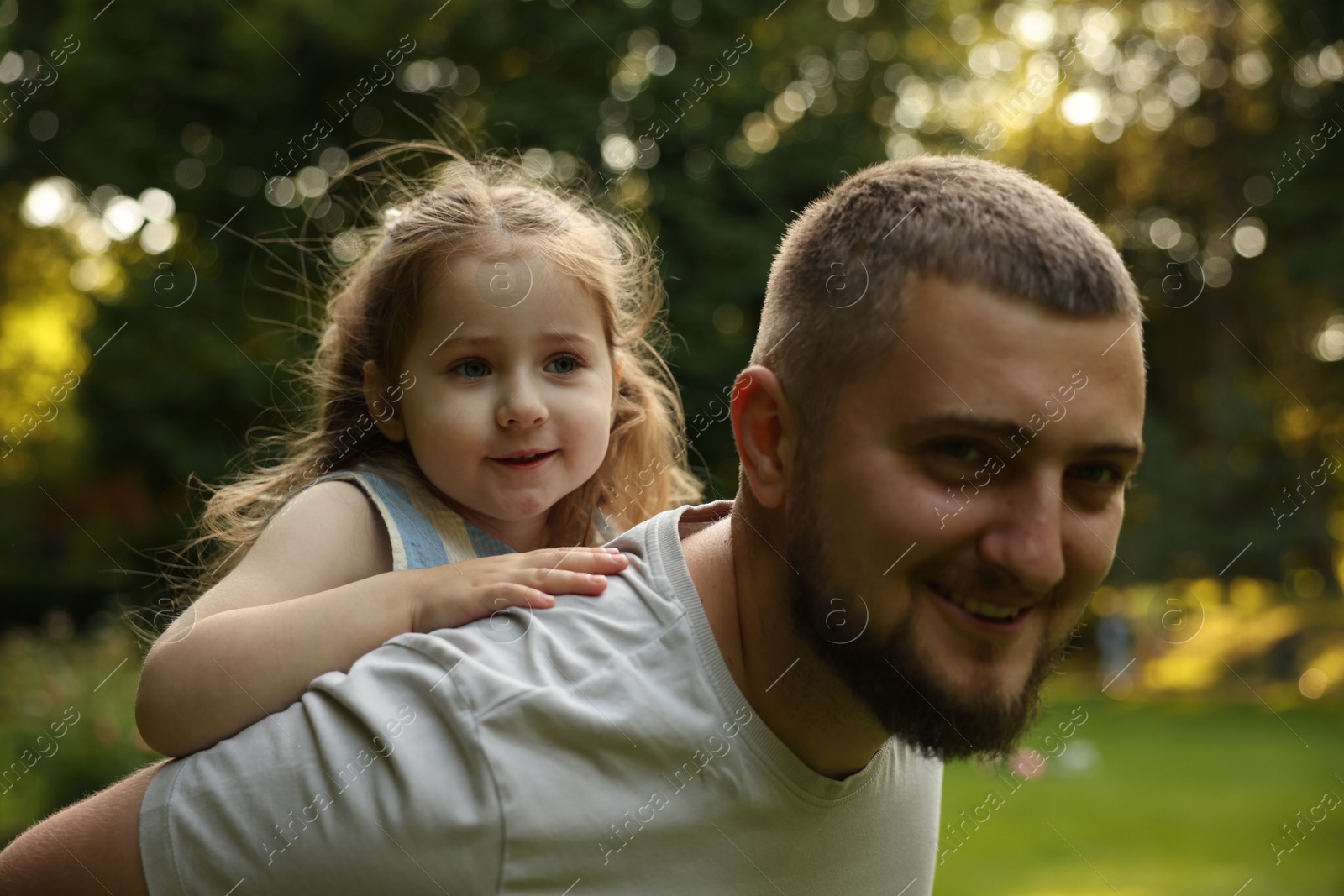 Happy Father's Day. Dad and his little daughter spending time together in park Photo of Happy Father's Day. Dad and his little daughter spending time together in park