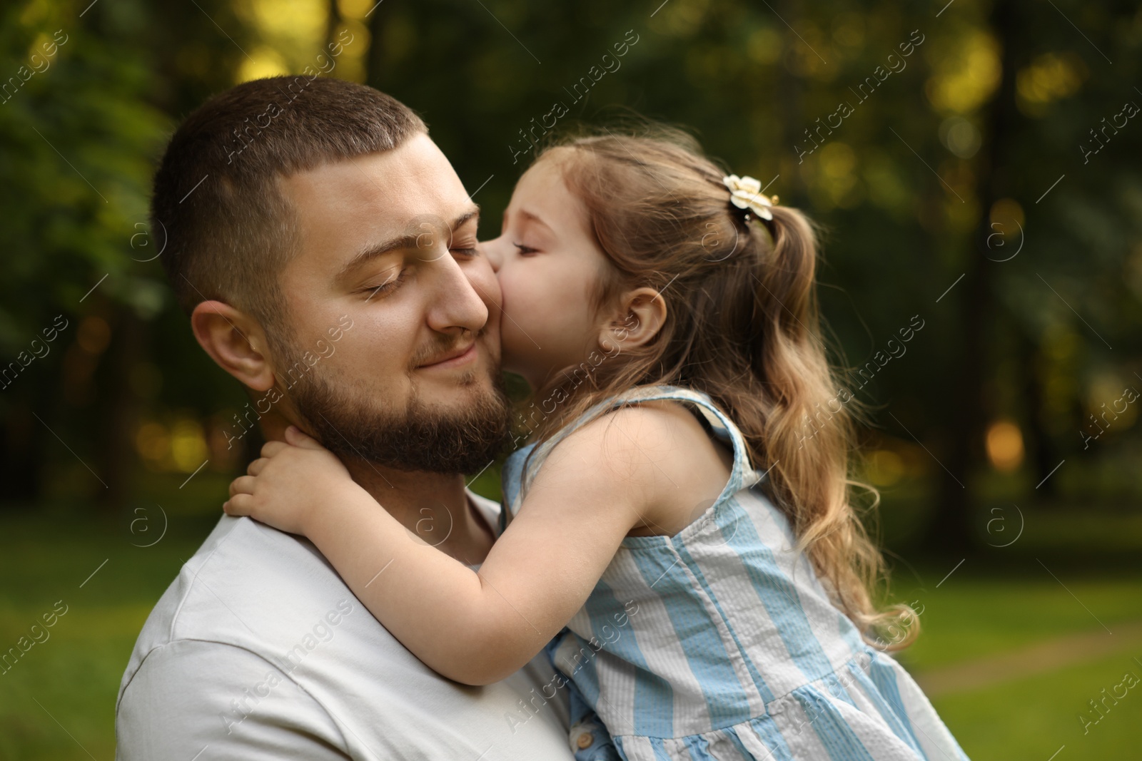 Happy Father's Day. Dad and his little daughter spending time together in park Photo of Happy Father's Day. Dad and his little daughter spending time together in park