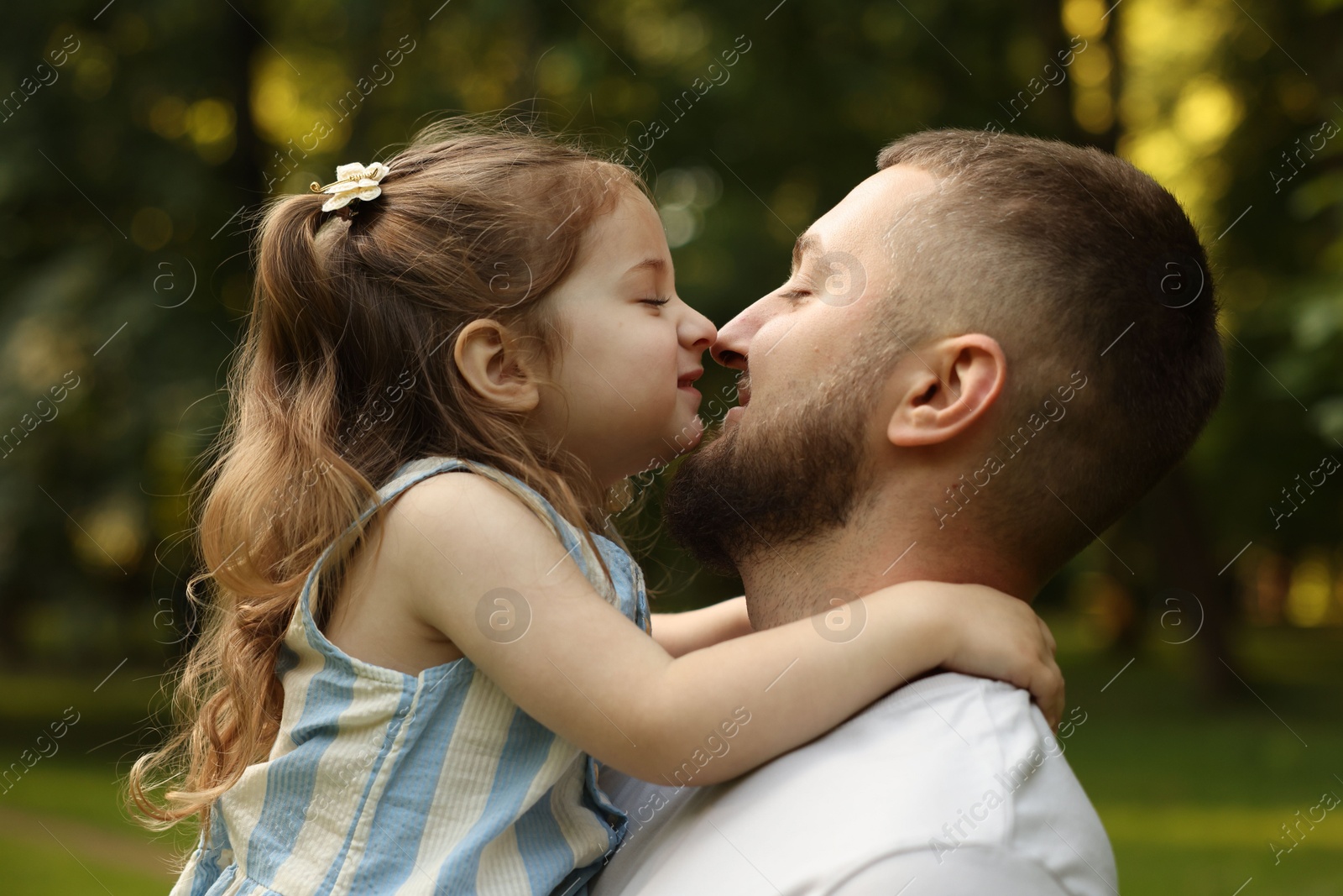 Happy Father's Day. Dad and his little daughter spending time together in park Photo of Happy Father's Day. Dad and his little daughter spending time together in park