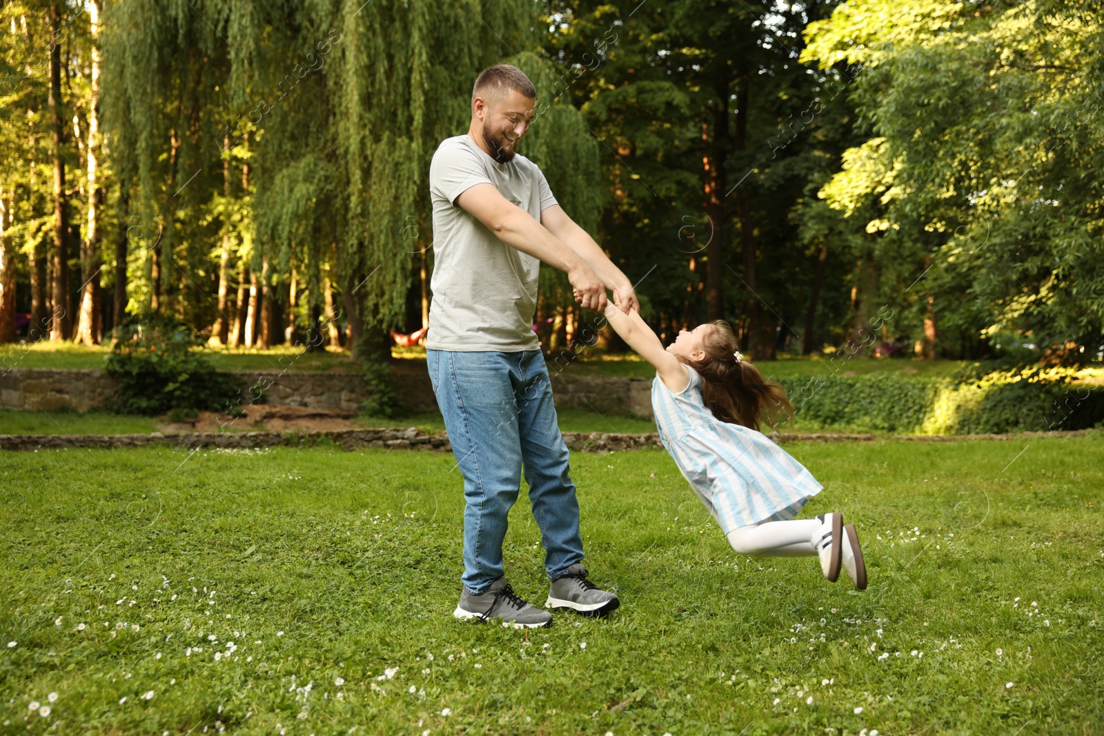Happy Father's Day. Dad and his little daughter spending time together in park Photo of Happy Father's Day. Dad and his little daughter spending time together in park