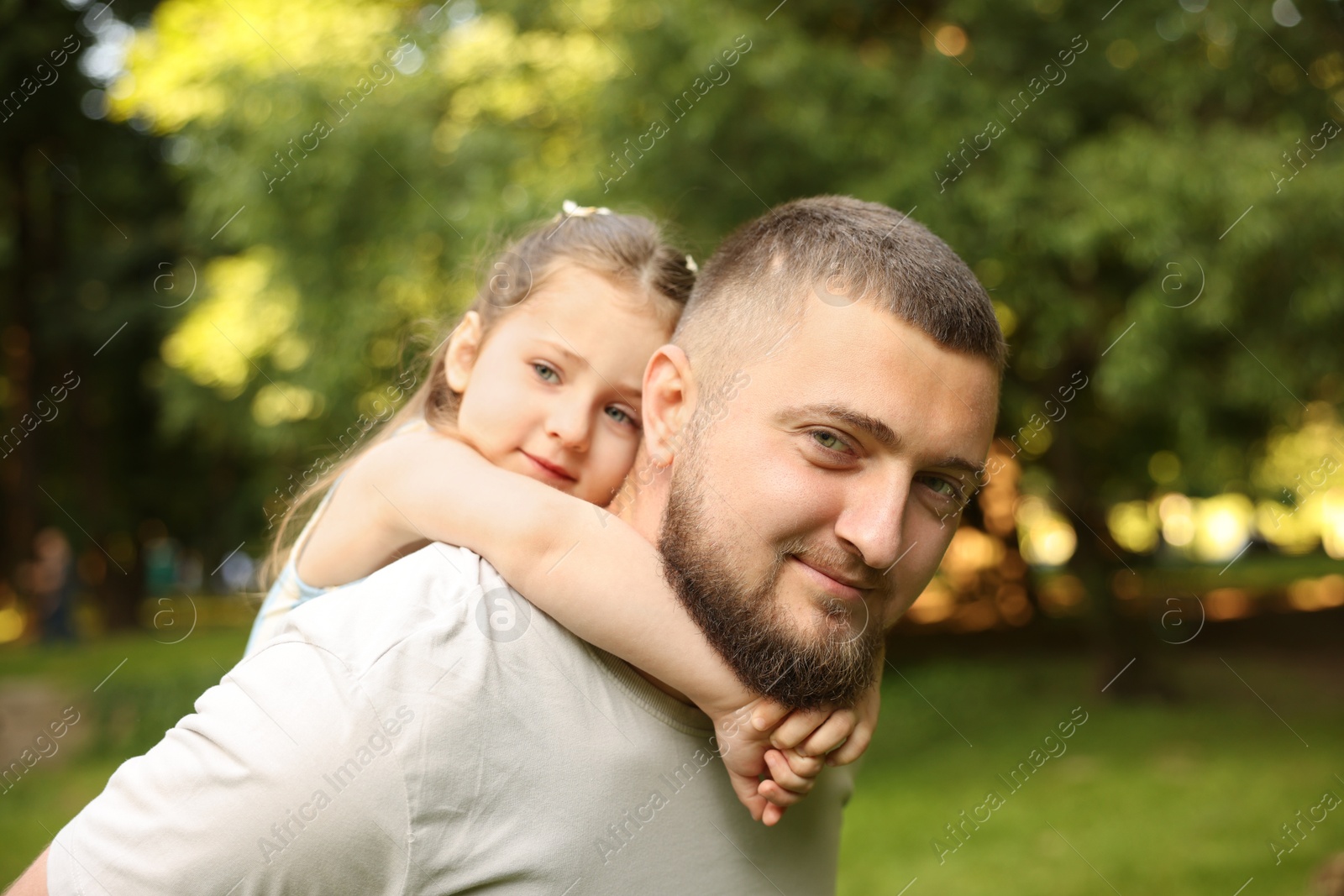 Happy Father's Day. Dad and his little daughter spending time together in park Photo of Happy Father's Day. Dad and his little daughter spending time together in park
