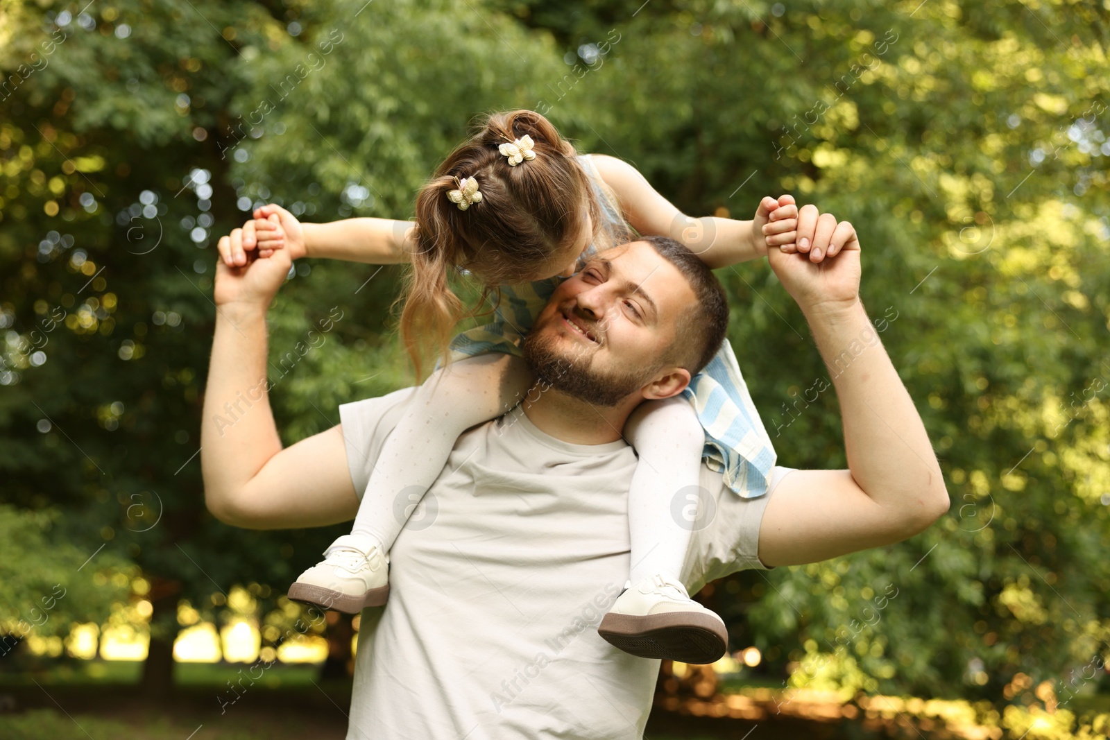 Happy Father's Day. Dad and his little daughter spending time together in park Photo of Happy Father's Day. Dad and his little daughter spending time together in park
