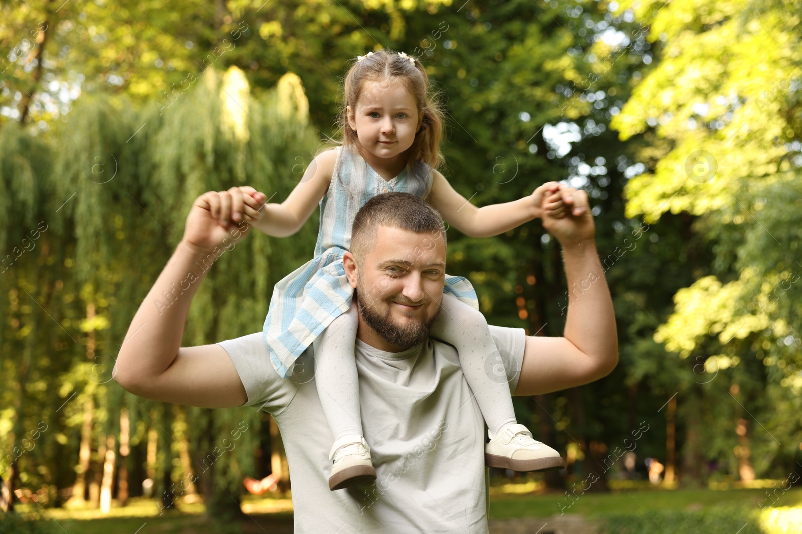 Happy Father's Day. Dad and his little daughter spending time together in park Photo of Happy Father's Day. Dad and his little daughter spending time together in park