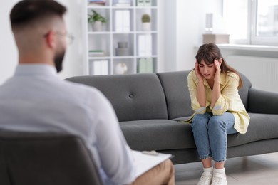 Photo of Professional psychologist working with patient in office, selective focus