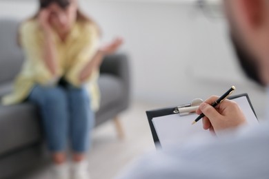 Photo of Professional psychologist working with patient in office, selective focus