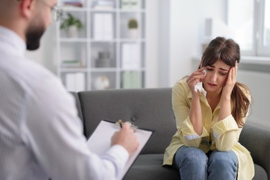 Photo of Professional psychologist working with patient in office, selective focus