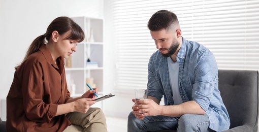 Photo of Professional psychologist working with patient in office
