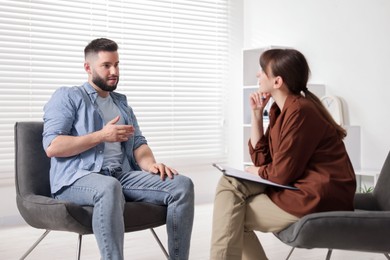 Photo of Professional psychologist working with patient in office