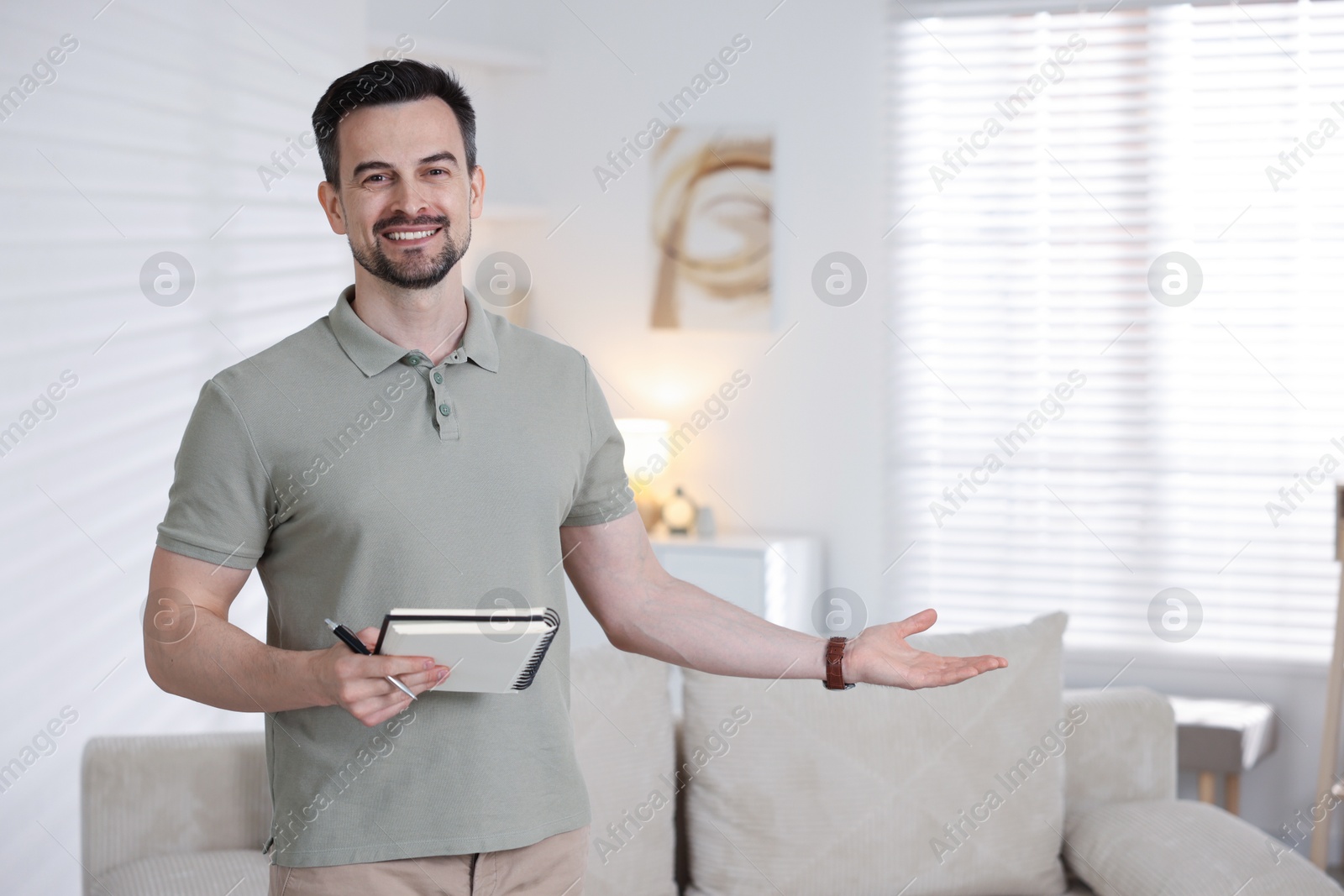 Professional psychologist with notebook inviting to his office. Space for text Photo of Professional psychologist with notebook inviting to his office. Space for text