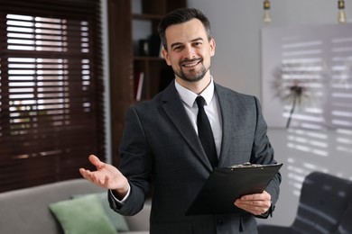 Photo of Professional psychologist with clipboard in his office