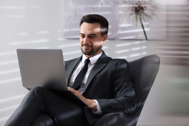 Photo of Professional psychologist having online consultation with his client via laptop indoors