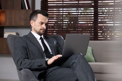 Photo of Professional psychologist having online consultation with his client via laptop indoors