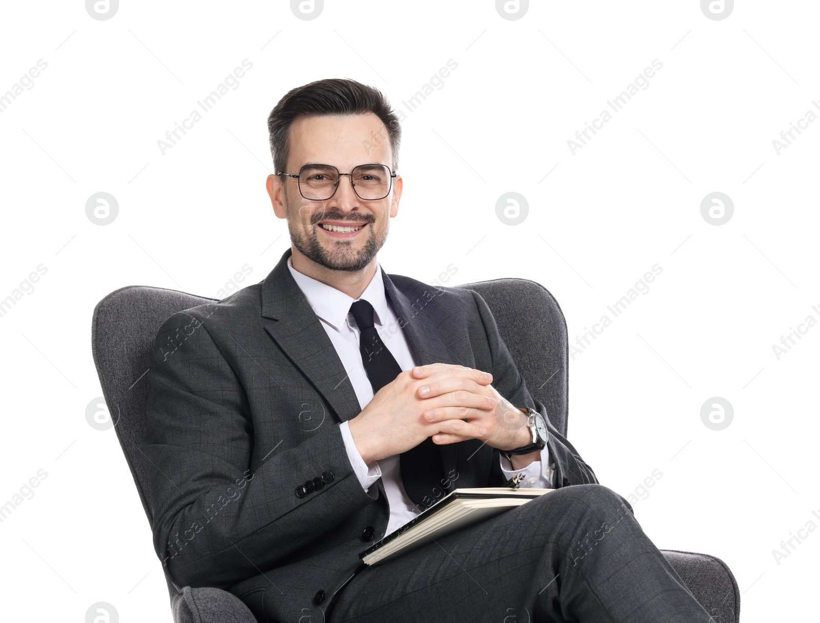 Professional psychologist with notebook in armchair on white background Photo of Professional psychologist with notebook in armchair on white background