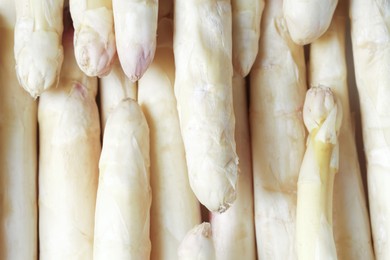 Photo of Raw white asparagus spears as background, closeup