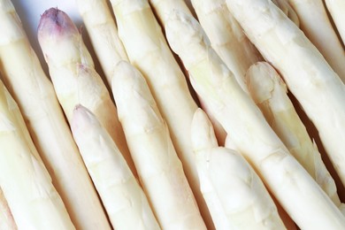 Photo of Raw white asparagus spears as background, closeup