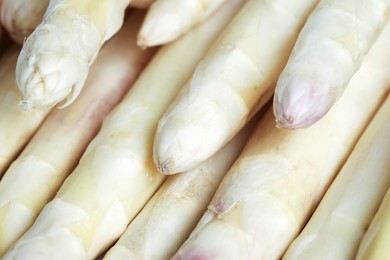 Photo of Raw white asparagus spears as background, closeup