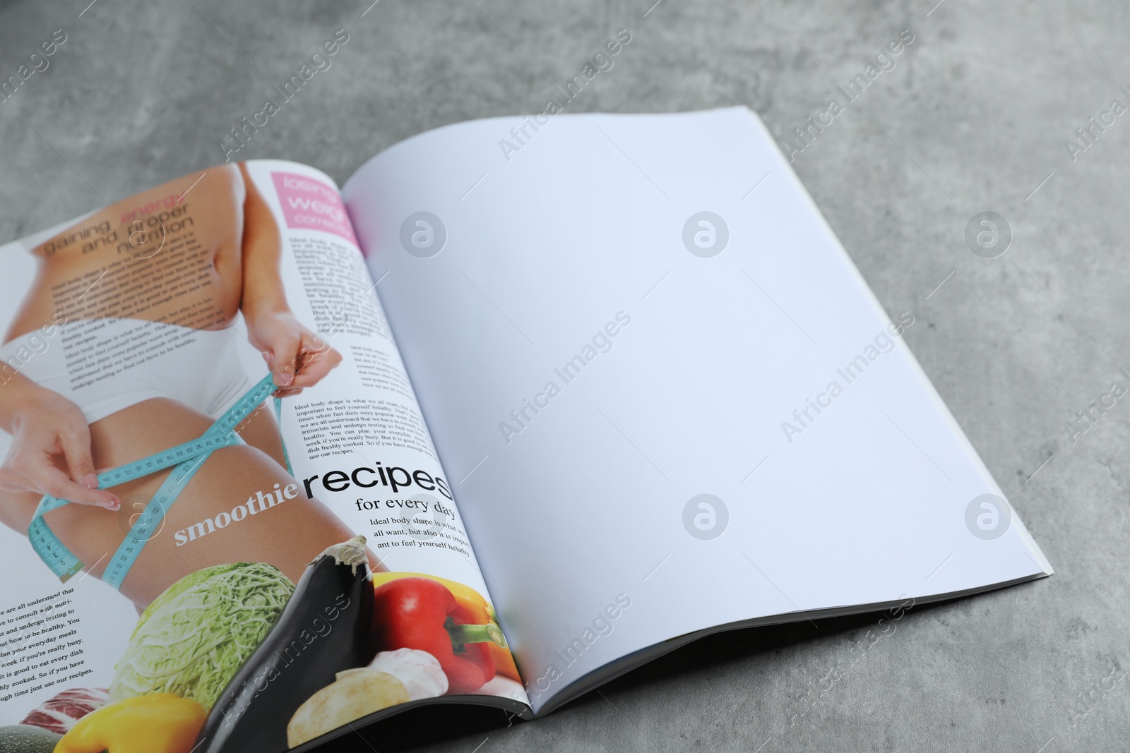 Open magazine on grey table, above view. Mockup for design Photo of Open magazine on grey table, above view. Mockup for design