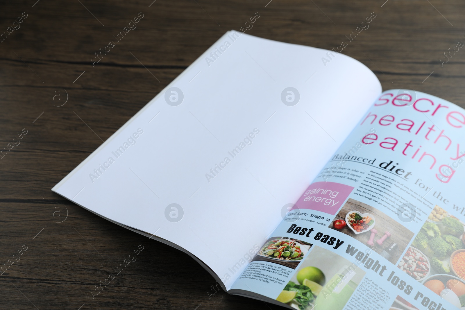 Open magazine on wooden table, above view. Mockup for design Photo of Open magazine on wooden table, above view. Mockup for design