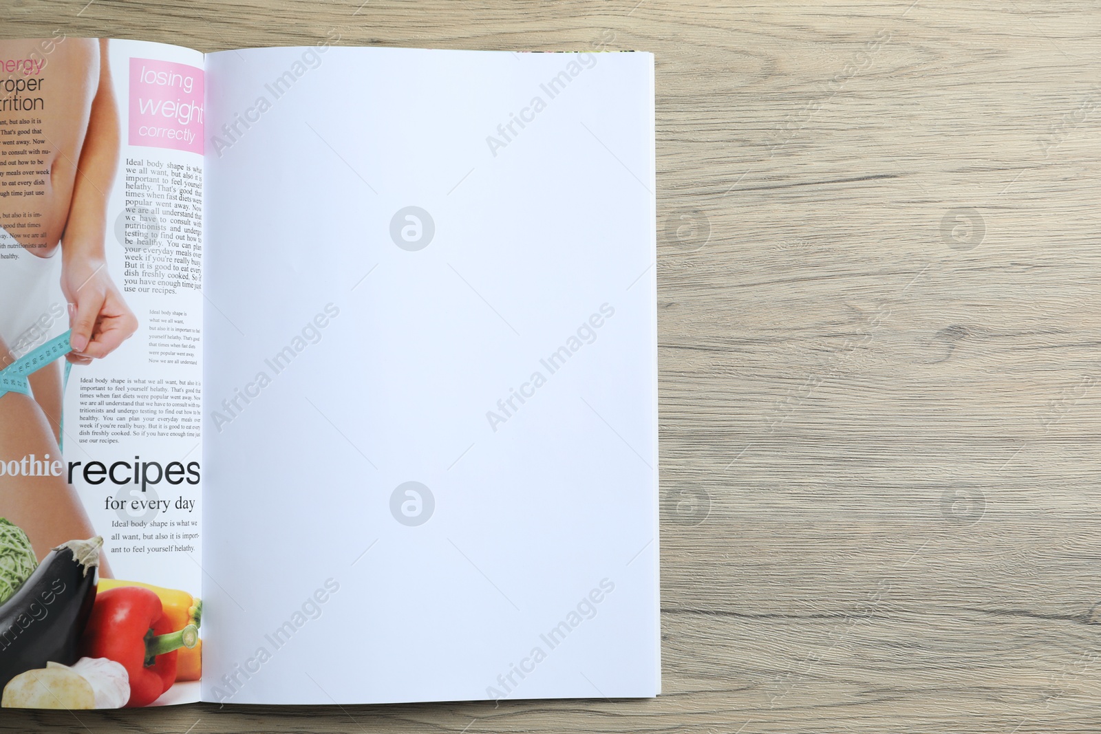 Open magazine on wooden table, top view. Mockup for design Photo of Open magazine on wooden table, top view. Mockup for design
