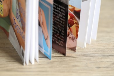 Photo of One open magazine on wooden table, closeup