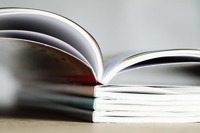 Photo of Stack of different magazines on table, closeup