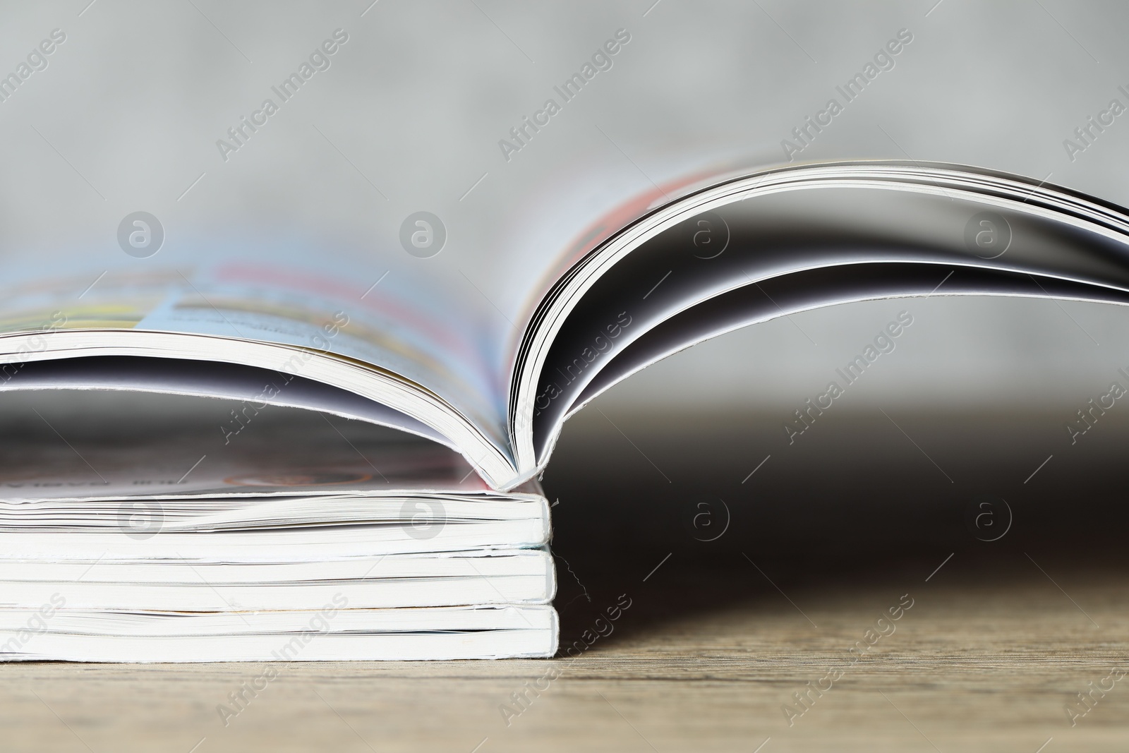 Stack of different magazines on wooden table, closeup Photo of Stack of different magazines on wooden table, closeup