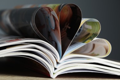 Photo of Many different open magazines on table, closeup
