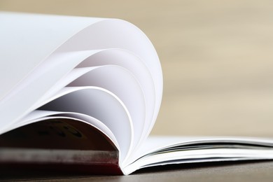 Photo of One open magazine on table, closeup view