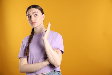 Photo of Portrait of shocked woman on orange background, space for text