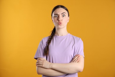 Photo of Portrait of shocked woman on orange background