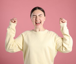 Photo of Portrait of surprised woman on pink background