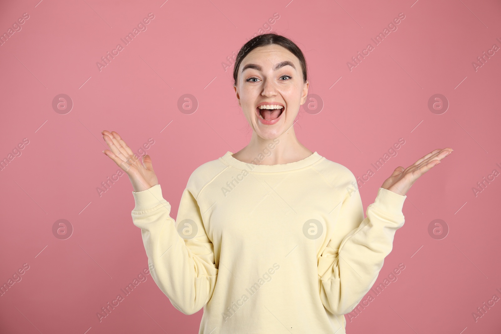 Portrait of surprised woman on pink background Photo of Portrait of surprised woman on pink background