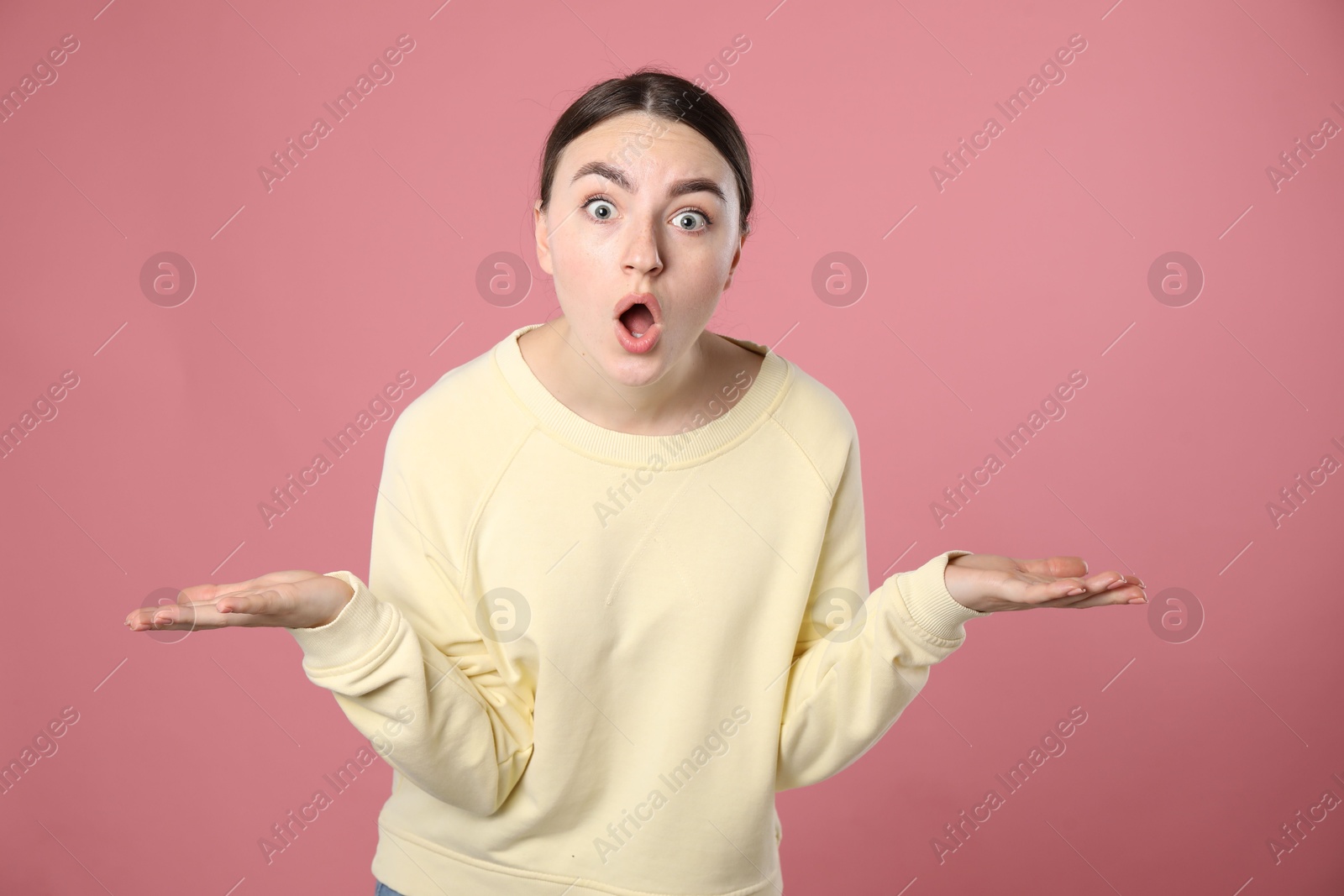 Portrait of shocked woman on pink background Photo of Portrait of shocked woman on pink background