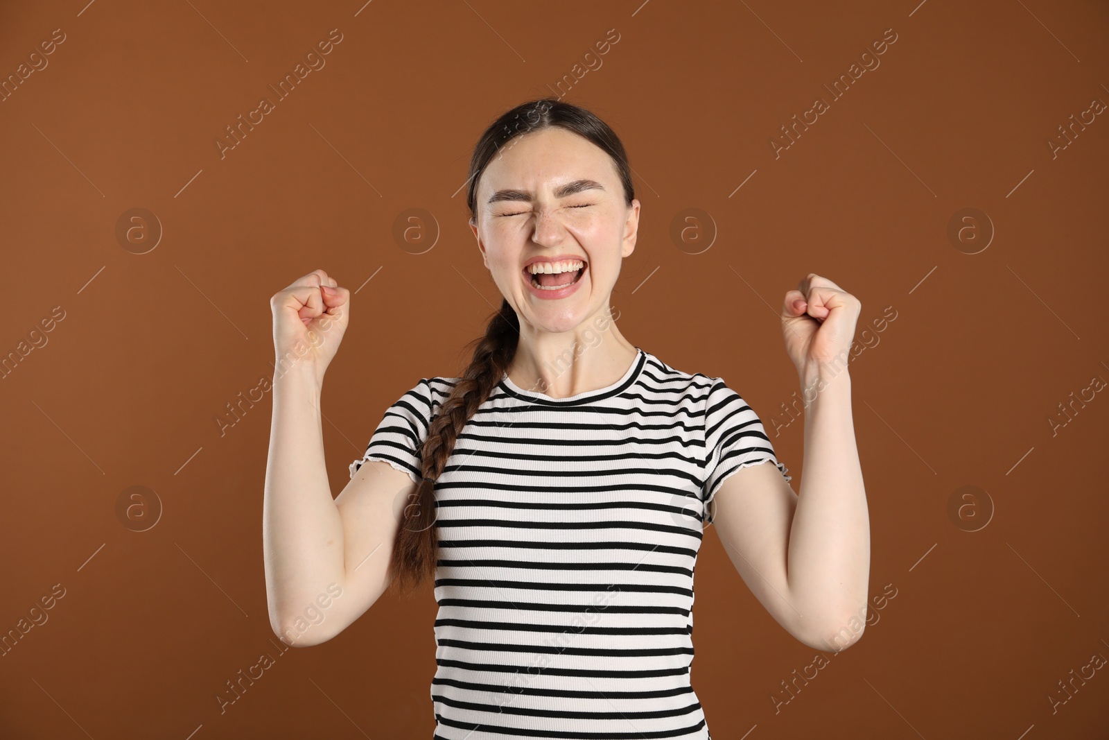 Portrait of surprised woman on brown background Photo of Portrait of surprised woman on brown background