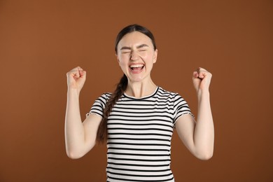 Photo of Portrait of surprised woman on brown background