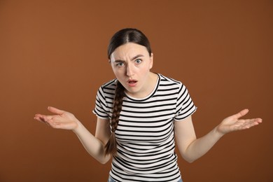 Photo of Portrait of shocked woman on brown background