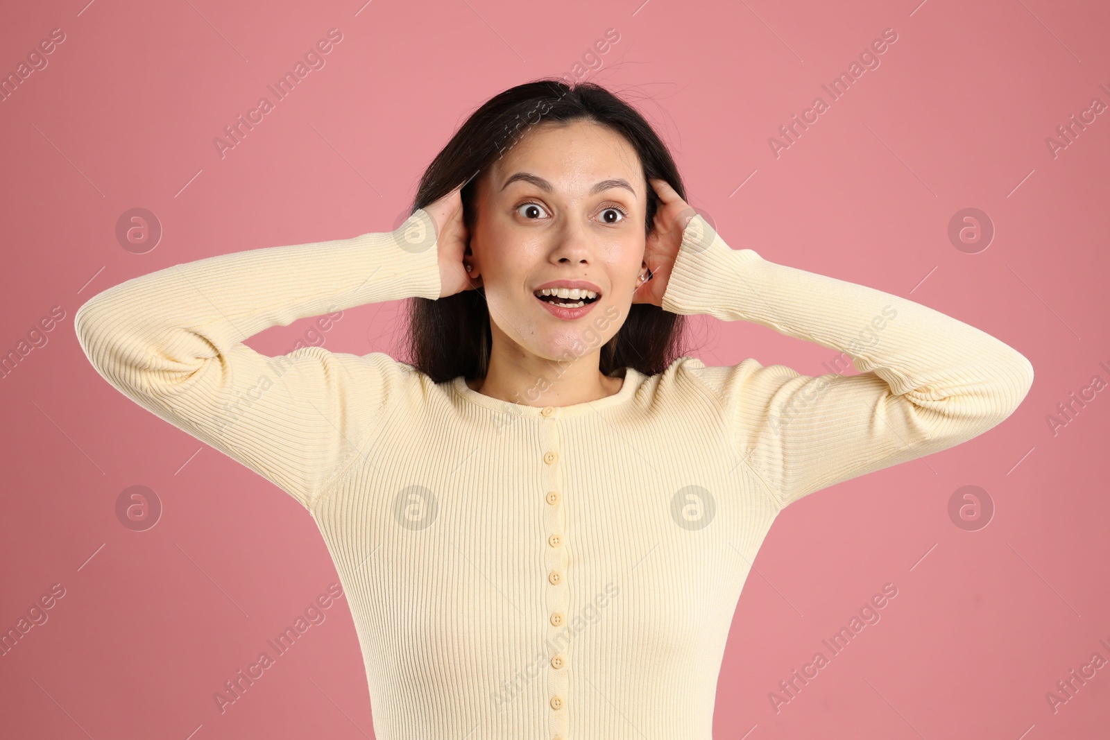 Photo of Portrait of surprised woman on pink background