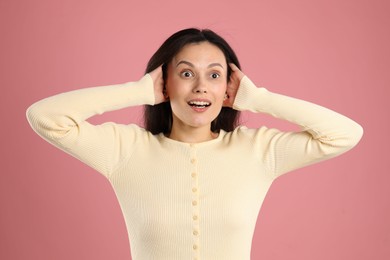Photo of Portrait of surprised woman on pink background