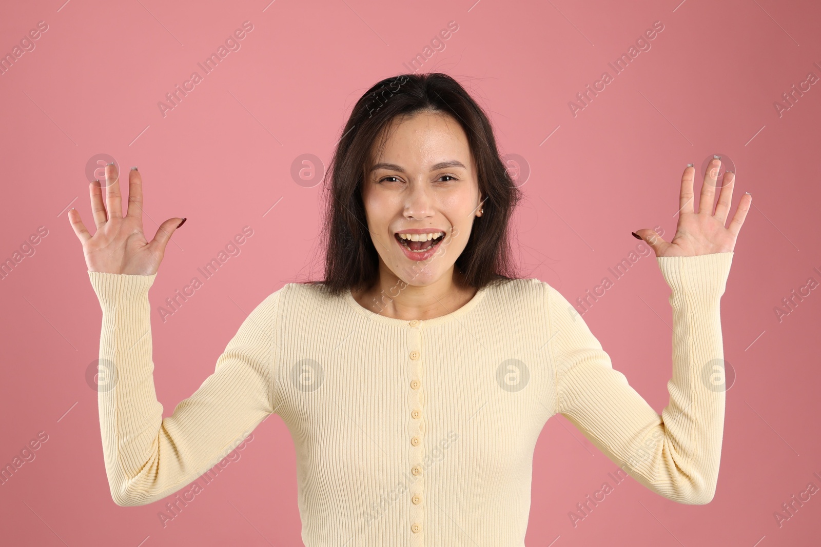 Portrait of surprised woman on pink background Photo of Portrait of surprised woman on pink background